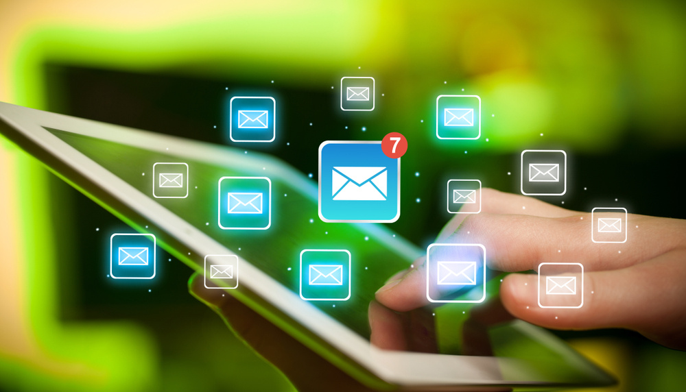 Female hands touching tablet with e-mail icons